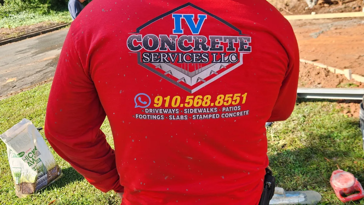 Crew pouring and finishing a concrete driveway