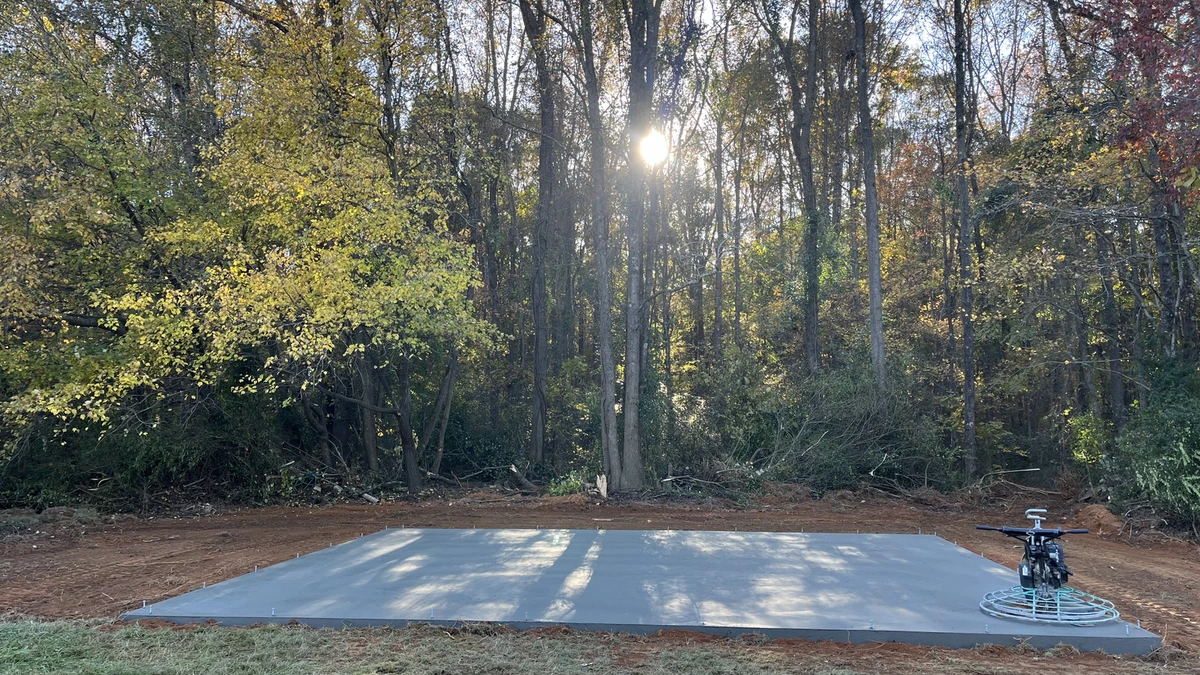 Aerial view of a freshly poured concrete driveway on a Charlotte home