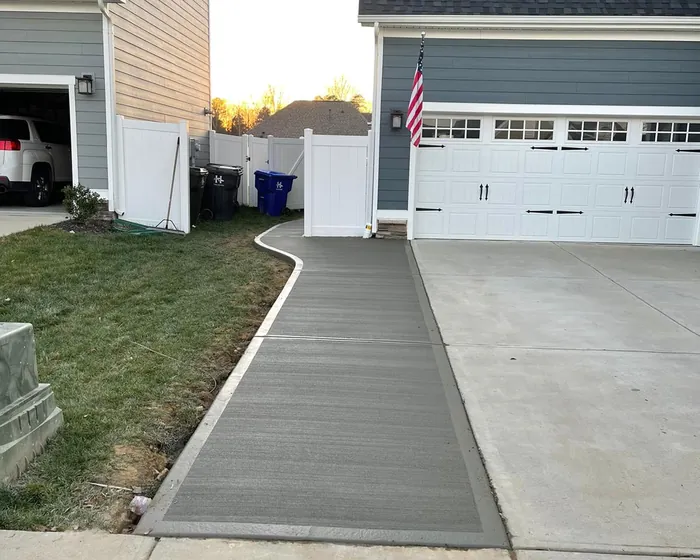 Finished concrete driveway running to a two car garage on a Charlotte home