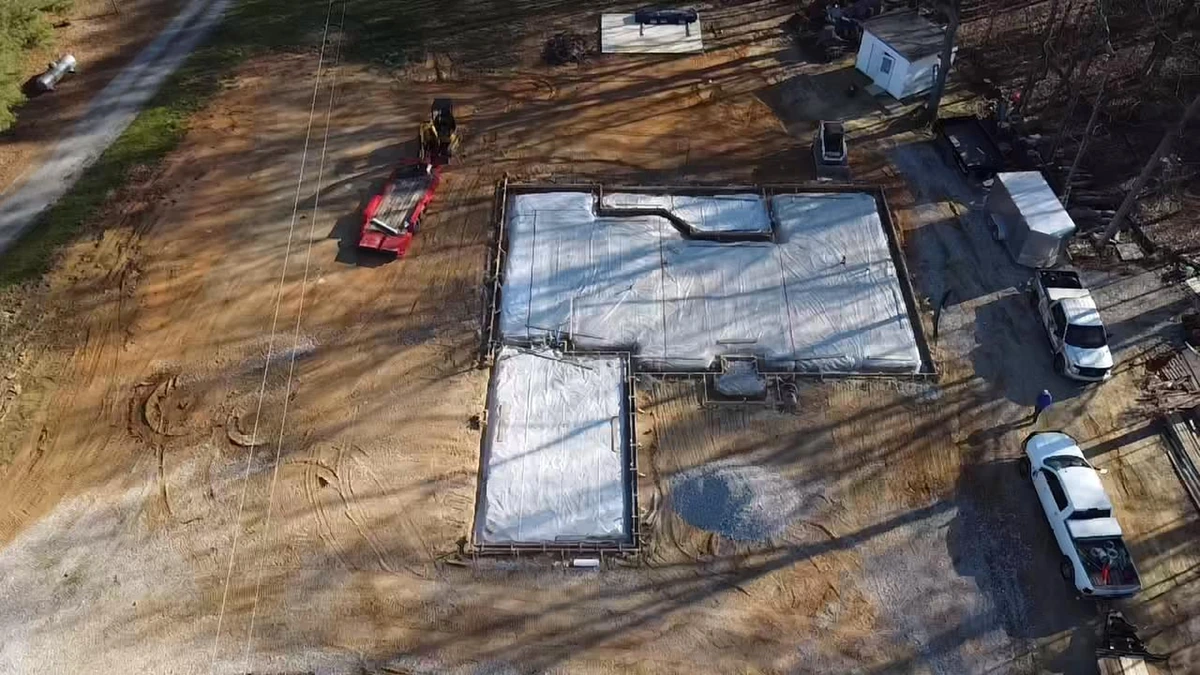 Aerial view of a freshly poured concrete driveway on a Charlotte home